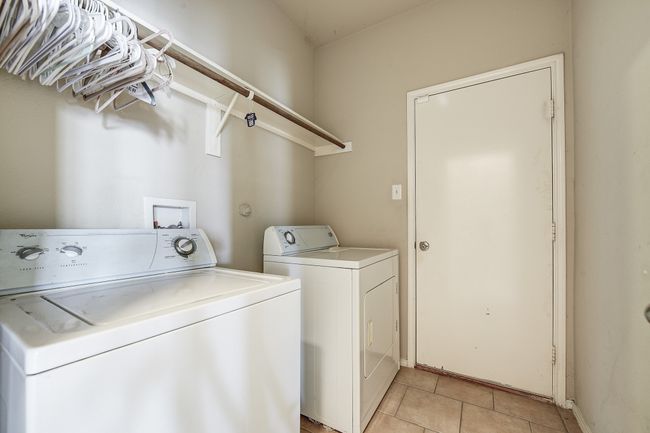 Washroom featuring light tile patterned floors and separate washer and dryer | Image 21