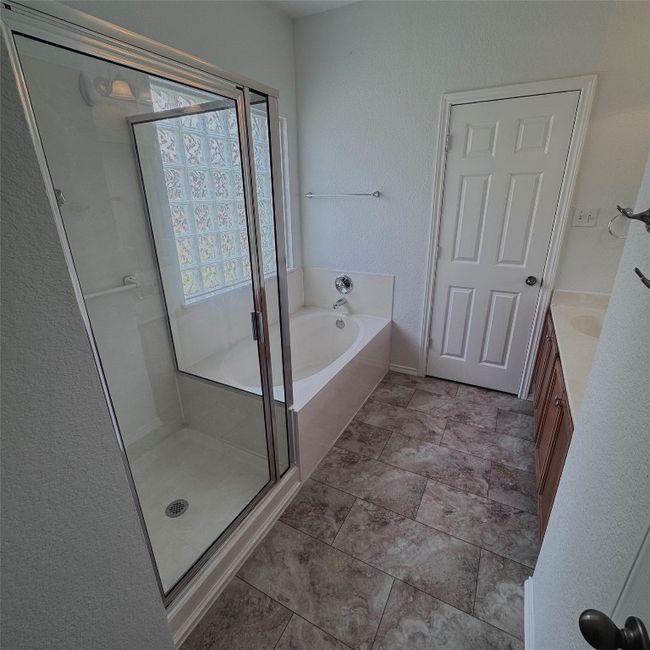 Full bath featuring a shower stall, a garden tub, and vanity | Image 13