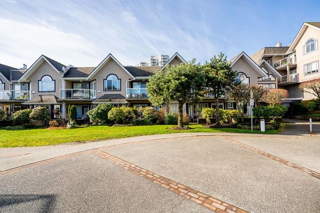 Multi unit property with a front lawn, a residential view, and stucco siding | Image 36