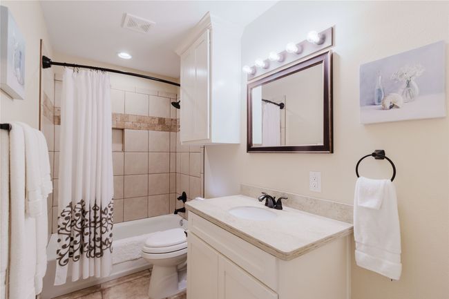 Full Guest bathroom with tile patterned floors, shower/tub combo | Image 13