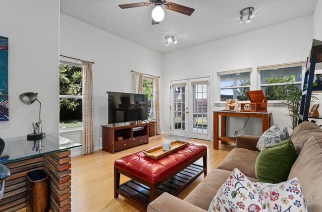 Living room featuring wood finished floors, a ceiling fan, and french doors | Image 6
