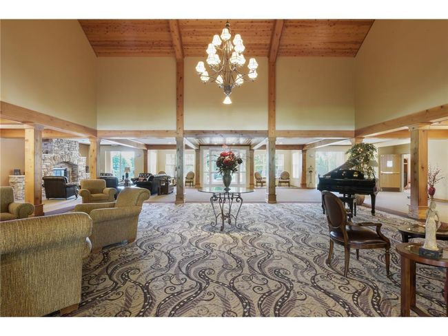 Owners and guests are welcomed by a grand entry with soaring ceilings, a massive stone fireplace, a grand piano, and enviting oalcoves for private conversations or quiet reading. | Image 20