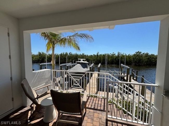 Balcony featuring a boat dock, a water view, and boat lift | Image 29