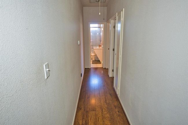 Hallway between the Primary Bedroom & other bedrooms. Main Bath on the end | Image 29