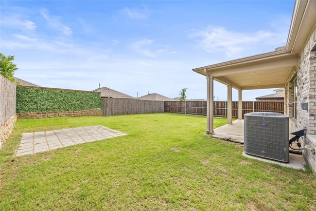 View of yard with cooling unit and a patio | Image 36