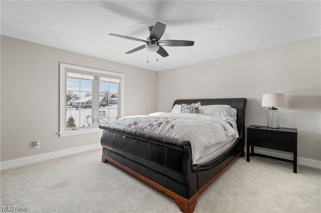 Carpeted bedroom with ceiling fan | Image 27