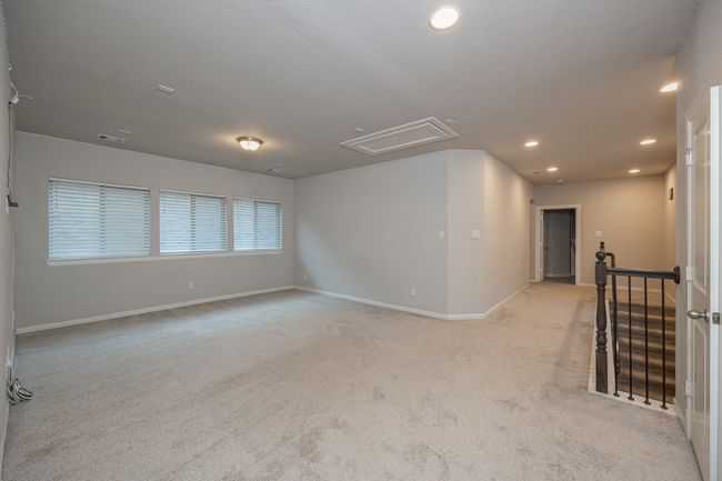 Unfurnished room with attic access, light colored carpet, and recessed lighting | Image 38