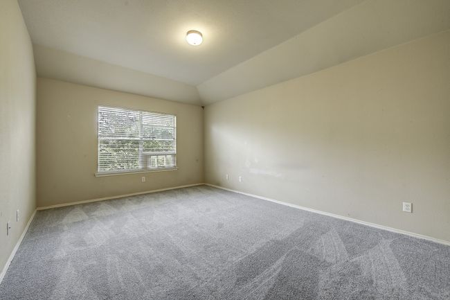 Unfurnished room with carpet flooring and lofted ceiling | Image 25