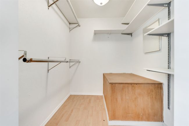 Walk in closet with light wood finished floors | Image 19