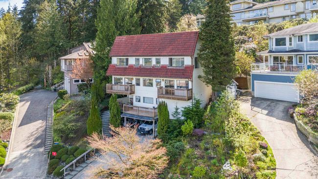 Exterior space with concrete driveway, a garage, and a tile roof | Image 11