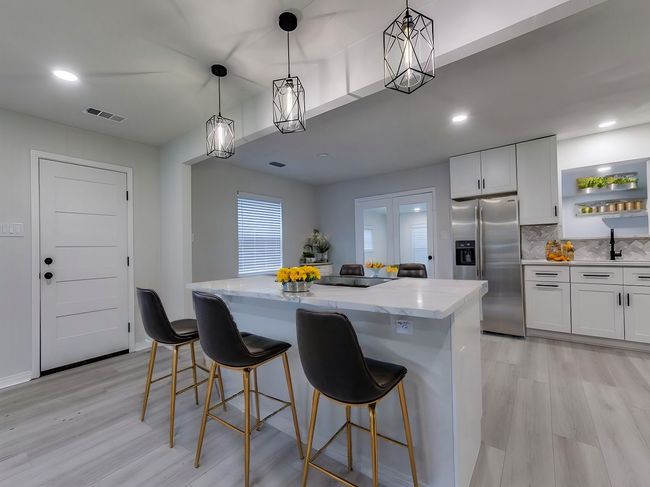 Virtually staged view from first living area into kitchen toward second living area | Image 4