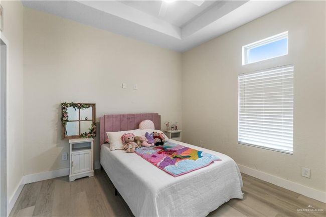 Bedroom featuring light hardwood / wood-style flooring and ceiling fan | Image 18