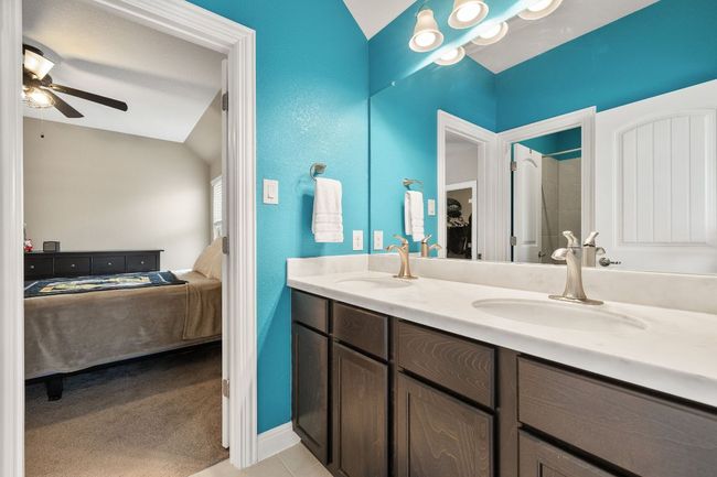 Full bath featuring ensuite bathroom, double vanity, ceiling fan, and baseboards | Image 35