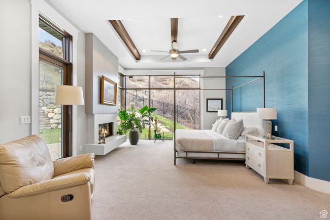 Bedroom featuring a tray ceiling, recessed lighting, a lit fireplace, and carpet floors | Image 42