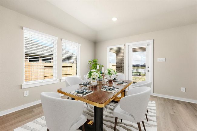 You and your guests will certainly dine in style in this amazing dining room! Featuring large windows with blinds, neutral paint, high ceilings, and luxury vinyl plank flooring. Perfect space to entertain family and friends. | Image 8