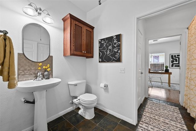 The bathroom features a tub/shower combination, a linen closet and storage. | Image 18