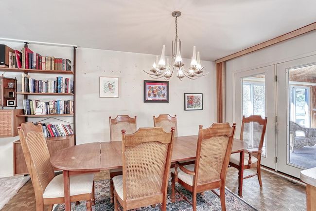 Dining area with french doors and an inviting chandelier | Image 8