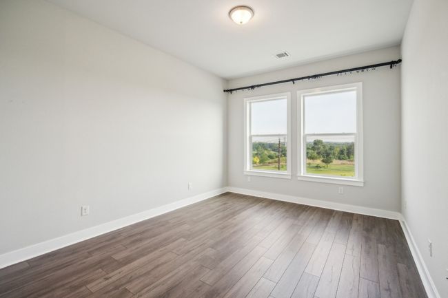 Spare room with baseboards and dark wood-style flooring | Image 7