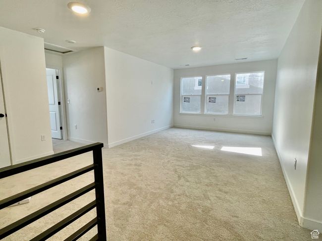 Unfurnished room featuring light carpet, a smoke detector, a textured ceiling, and recessed lighting | Image 10