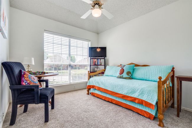 One of two secondary bedrooms, this room overlooks the front yard and includes a ceiling fan and neutral color scheme. Fresh paint and carpet were completed in the bedrooms in 2022. | Image 20