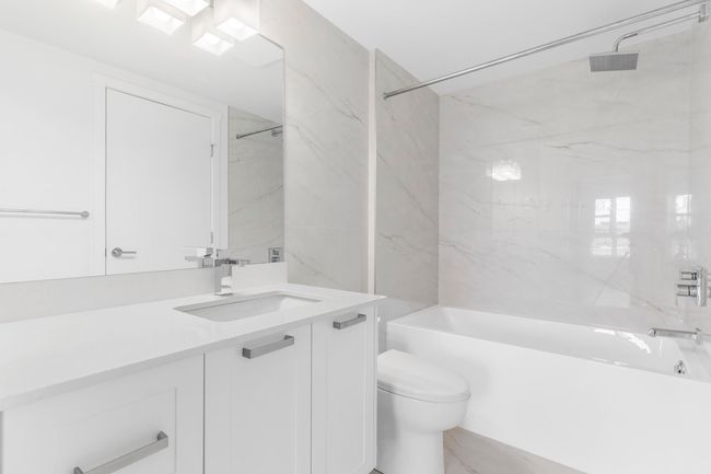 Full bath featuring vanity, toilet, and shower / tub combination | Image 14