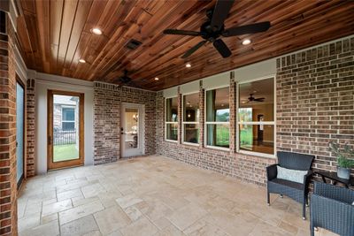 Imagine relaxing on the the large Back Patio has been closed in and equipped with Central Air. It looks out over a Green Space and features a Gleaming Wood Ceiling Design, Canned Lighting, and a neutral and popular style Tile and high end Wood Doors with Brass Hardware. | Image 2