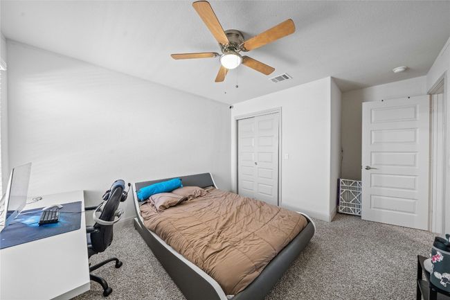 Carpeted bedroom featuring baseboards, visible vents, a closet, and a ceiling fan | Image 26