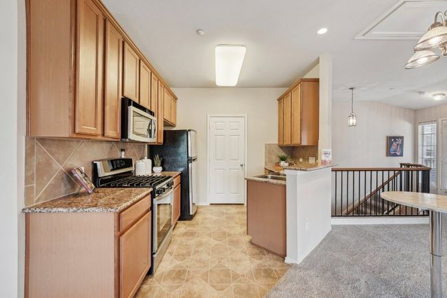 Stylish & Functional – Granite countertops, modern appliances, and ample cabinetry make this kitchen a joy to use. | Image 16