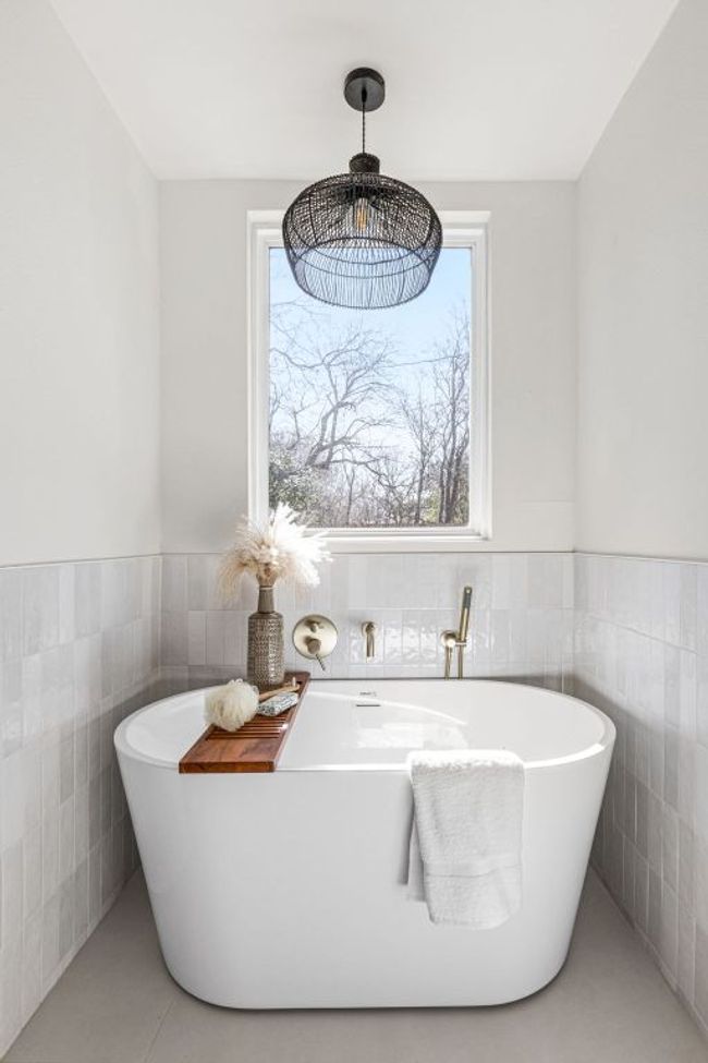 Full bathroom with tile walls, a soaking tub, wainscoting, and tile patterned flooring | Image 28