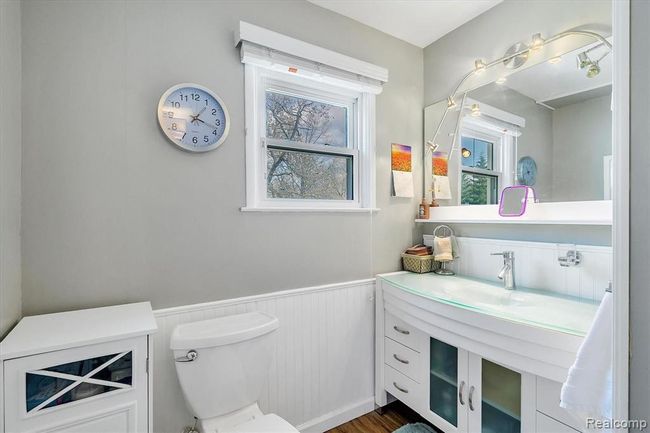 View of remodeled bathroom with new vanity, glass shower, flooring and toilet | Image 14