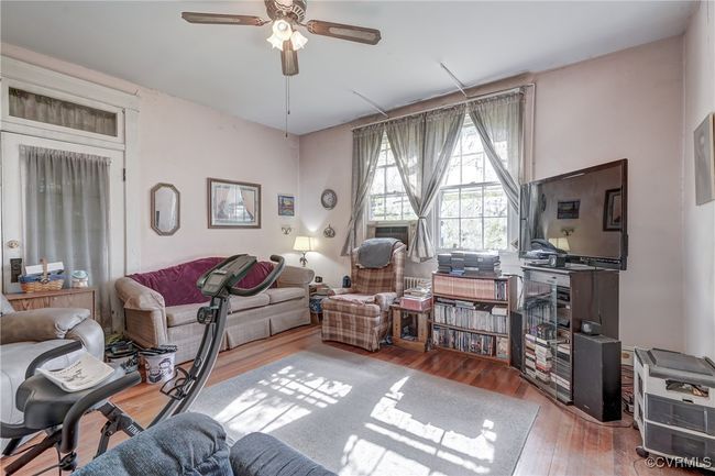 Living area with wood finished floors and a ceiling fan | Image 17