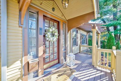 Stone steps, the newly rebuilt covered front porch and original French doors greet you and your guests. | Image 3