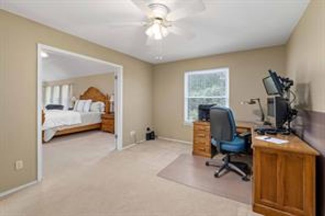 Office area with light colored carpet and ceiling fan | Image 24