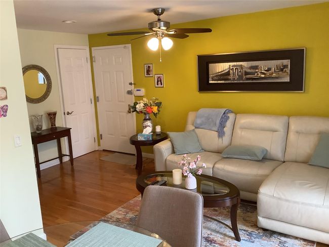 Living area with wood finished floors and ceiling fan | Image 10