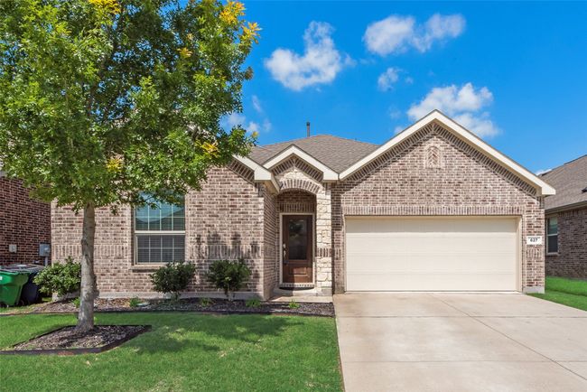 View of front of home featuring brick siding, a garage, concrete driveway, a front yard, and a shingled roof | Image 26