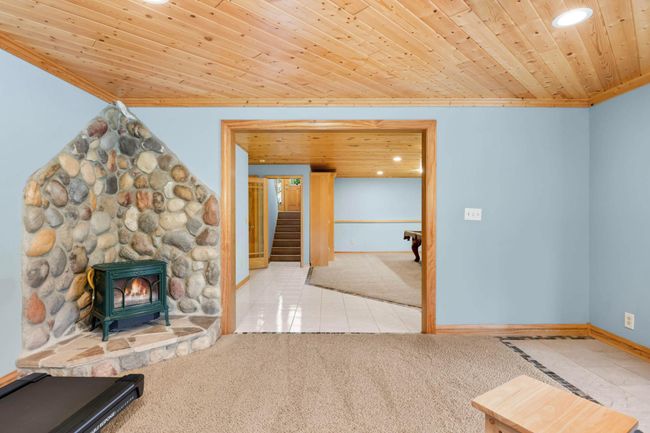 A free standing fireplace is located in the Lower Level Family Room - so cozy! | Image 28