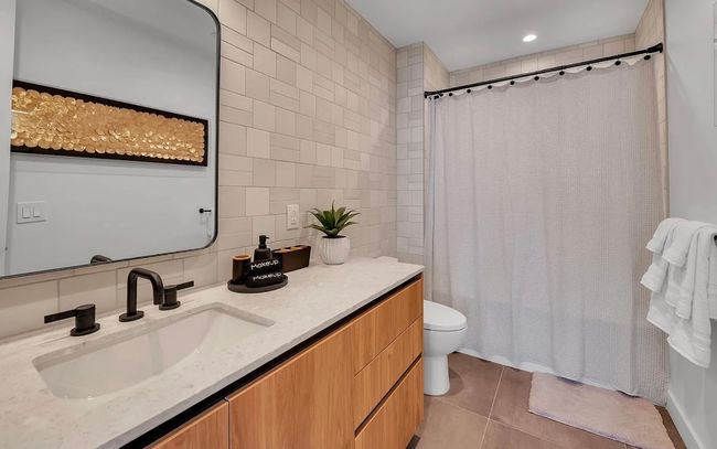 Bathroom featuring tile walls, vanity, tile patterned flooring, tasteful backsplash, and a shower with curtain | Image 13