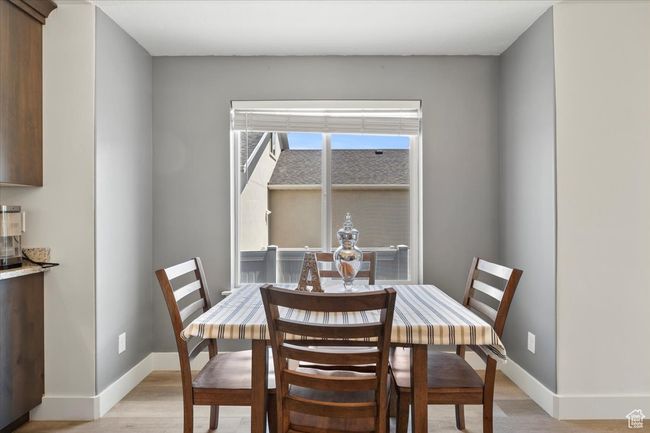 Dining area with light wood finished floors and baseboards | Image 11