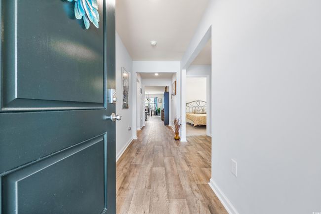 Corridor featuring wood finished floors and baseboards | Image 4