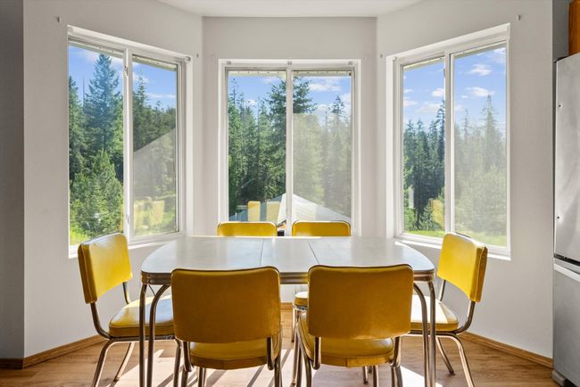 Dining space with plenty of natural light and wood finished floors | Image 13