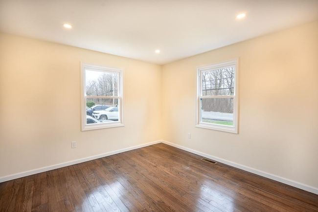 Unfurnished bedroom #2 featuring baseboards, dark wood finished floors, visible vents, and recessed lighting | Image 17