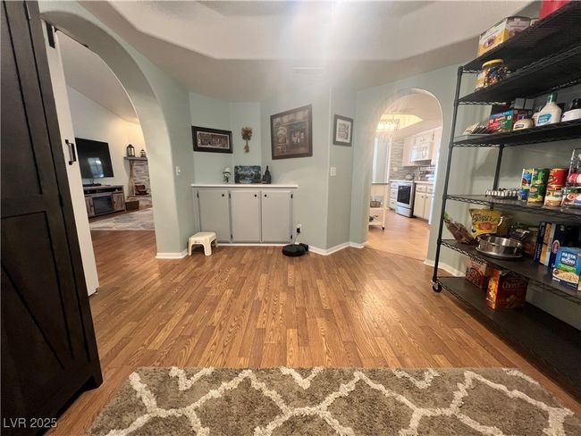 Corridor featuring arched walkways and light wood finished floors | Image 10