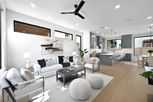 Living room featuring light hardwood / wood-style floors, sink, ceiling fan, and a healthy amount of sunlight | Image 10