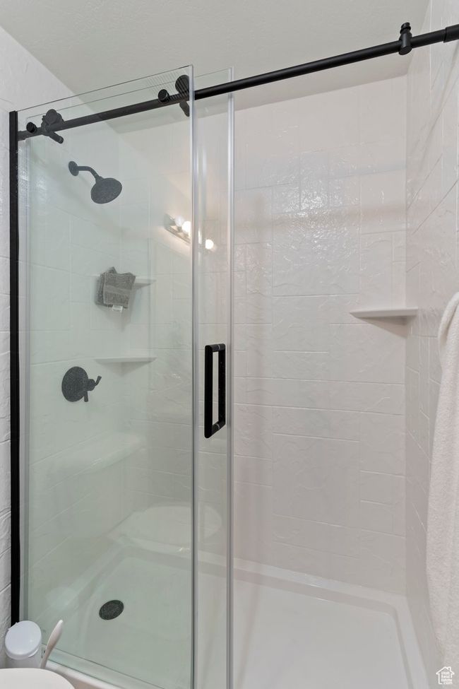 Bathroom featuring a stall shower and toilet | Image 20