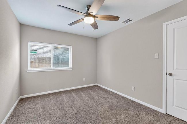 Spare room with ceiling fan and carpet floors | Image 24