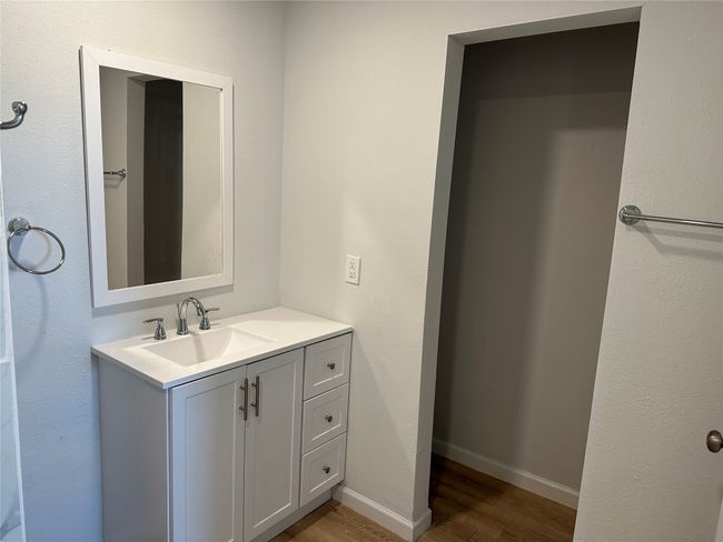 Bathroom with baseboards, vanity, and wood finished floors | Image 10