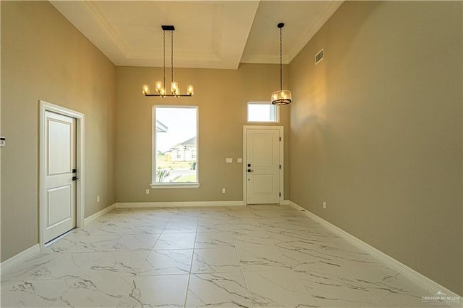 Entryway featuring marble finish floor, visible vents, baseboards, and a tray ceiling | Image 18