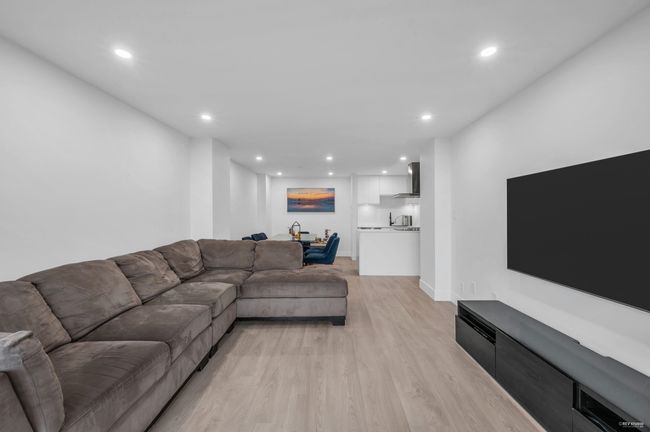 Living area with bar, recessed lighting, and light wood-style flooring | Image 5