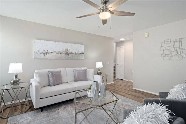Living area with baseboards, wood finished floors, and ceiling fan | Image 10
