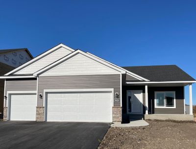 9824 32nd St NE- Home will be ready for move-in 11/20/24! Highlights include an unfinished walkout lower level, stone accents, & Pella windows. Sod, irrigation system, and front yard landscaping included. | Image 1